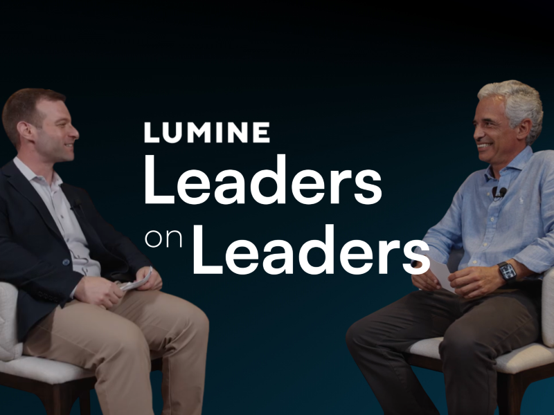 Two men sitting in chairs with fake background and the Leaders on Leaders logo