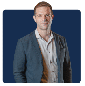 Headshot of SVP, Elliot Yunger on blue background. 